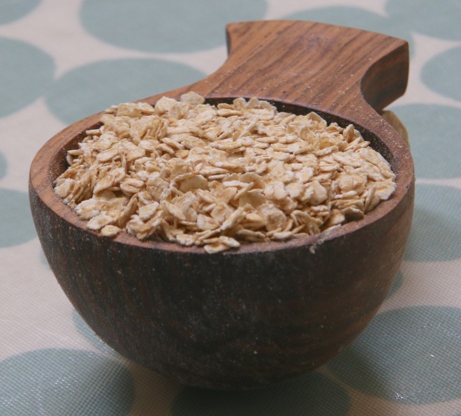 Walnut measuring cup with oats